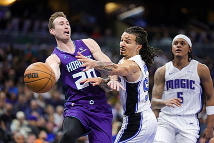 Nov 26, 2023; Orlando, Florida, USA;  Charlotte Hornets forward Gordon Hayward (20) passes the ball past Orlando Magic guard Cole Anthony (50) in the fourth quarter at Amway Center. Mandatory Credit: Nathan Ray Seebeck-USA TODAY Sports