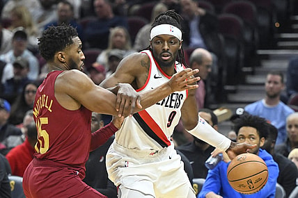 Nov 30, 2023; Cleveland, Ohio, USA; Portland Trail Blazers forward Jerami Grant (9) drives against Cleveland Cavaliers guard Donovan Mitchell (45) in the second quarter at Rocket Mortgage FieldHouse. Mandatory Credit: David Richard-USA TODAY Sports