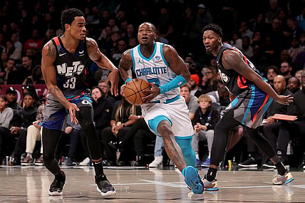 Nov 30, 2023; Brooklyn, New York, USA; Charlotte Hornets guard Terry Rozier (3) drives to the basket against Brooklyn Nets center Nic Claxton (33) and forward Dorian Finney-Smith (28) during the fourth quarter at Barclays Center. Mandatory Credit: Brad Penner-USA TODAY Sports