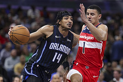 Dec 1, 2023; Orlando, Florida, USA;  Orlando Magic guard Gary Harris (14) drives to the basket past Washington Wizards guard Johnny Davis (1) in the second quarter at Amway Center. Mandatory Credit: Nathan Ray Seebeck-USA TODAY Sports