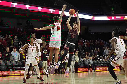 Nov 29, 2023; Los Angeles, California, USA; Eastern Washington Eagles guard Jake Kyman (13) shoots the ball against Southern California Trojans forward DJ Rodman (10)  in the first half at Galen Center. Mandatory Credit: Kirby Lee-USA TODAY Sports
