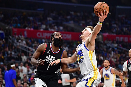 Dec 2, 2023; Los Angeles, California, USA; Golden State Warriors guard Brandin Podziemski (2) moves to the basket against Los Angeles Clippers guard James Harden (1) during the first half at Crypto.com Arena. Mandatory Credit: Gary A. Vasquez-USA TODAY Sports
