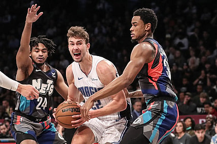 Dec 2, 2023; Brooklyn, New York, USA;  Orlando Magic forward Franz Wagner (22) looks to drive in between Brooklyn Nets guard Cam Thomas (24) and center Nic Claxton (33) in the second quarter at Barclays Center. Mandatory Credit: Wendell Cruz-USA TODAY Sports
