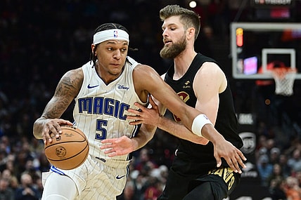 Dec 6, 2023; Cleveland, Ohio, USA; Orlando Magic forward Paolo Banchero (5) drives to the basket against Cleveland Cavaliers forward Dean Wade (32) during the first half at Rocket Mortgage FieldHouse. Mandatory Credit: Ken Blaze-USA TODAY Sports