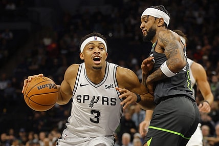 Dec 6, 2023; Minneapolis, Minnesota, USA; San Antonio Spurs forward Keldon Johnson (3) works against Minnesota Timberwolves guard Nickeil Alexander-Walker (9) in the first quarter at Target Center. Mandatory Credit: Bruce Kluckhohn-USA TODAY Sports