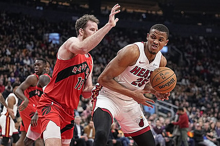 Dec 6, 2023; Toronto, Ontario, CAN; Miami Heat center Orlando Robinson (25) tries to around Toronto Raptors center Jakob Poeltl (19) during the first half at Scotiabank Arena. Mandatory Credit: John E. Sokolowski-USA TODAY Sports
