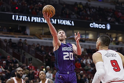Dec 6, 2023; Chicago, Illinois, USA; Charlotte Hornets forward Gordon Hayward (20) goes to the basket against Chicago Bulls center Nikola Vucevic (9) during the first half at United Center. Mandatory Credit: Kamil Krzaczynski-USA TODAY Sports