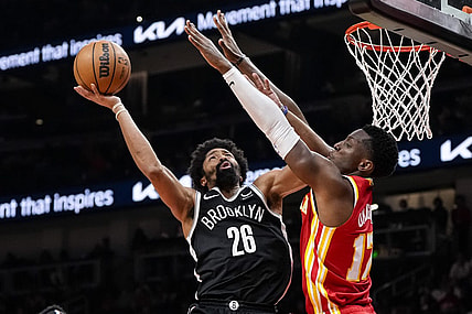 Dec 6, 2023; Atlanta, Georgia, USA; Brooklyn Nets guard Spencer Dinwiddie (26) shoots defended by Atlanta Hawks forward Onyeka Okongwu (17) during the second half at State Farm Arena. Mandatory Credit: Dale Zanine-USA TODAY Sports