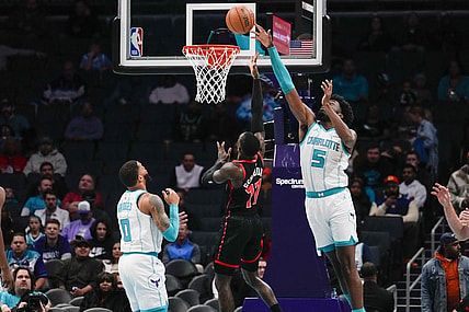 Dec 8, 2023; Charlotte, North Carolina, USA; Charlotte Hornets center Mark Williams (5) blocks a shot by Toronto Raptors guard Dennis Schroder (17)  during the first quarter at the Spectrum Center. Mandatory Credit: Jim Dedmon-USA TODAY Sports