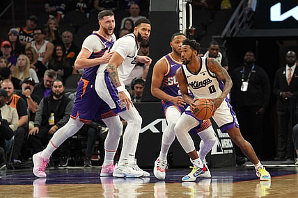 Dec 8, 2023; Phoenix, Arizona, USA; Sacramento Kings guard Malik Monk (0) controls the ball against the Phoenix Suns during the first half at Footprint Center. Mandatory Credit: Joe Camporeale-USA TODAY Sports