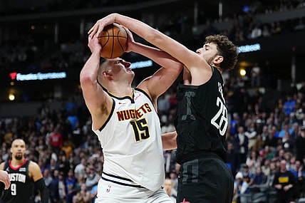 Dec 8, 2023; Denver, Colorado, USA; Houston Rockets center Alperen Sengun (28) blocks a shot by Denver Nuggets center Nikola Jokic (15) in the second half at Ball Arena. Mandatory Credit: Ron Chenoy-USA TODAY Sports