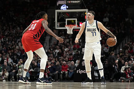 Dec 8, 2023; Portland, Oregon, USA; Dallas Mavericks point guard Luka Doncic (77) brings the ball up court against Portland Trail Blazers forward Jabari Walker (34) during the second half at Moda Center. Mandatory Credit: Soobum Im-USA TODAY Sports