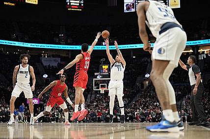 Dec 8, 2023; Portland, Oregon, USA; Dallas Mavericks point guard Luka Doncic (77) shoots the ball over Portland Trail Blazers forward Toumani Camara (33) during the second half at Moda Center. Mandatory Credit: Soobum Im-USA TODAY Sports