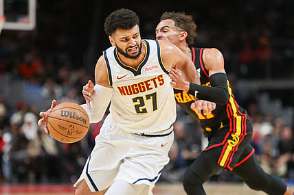 Dec 11, 2023; Atlanta, Georgia, USA; Denver Nuggets guard Jamal Murray (27) is fouled by Atlanta Hawks guard Trae Young (11) in the second quarter at State Farm Arena. Mandatory Credit: Brett Davis-USA TODAY Sports