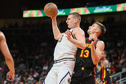 Dec 11, 2023; Atlanta, Georgia, USA; Denver Nuggets center Nikola Jokic (15) is defended by Atlanta Hawks guard Bogdan Bogdanovic (13) in the second quarter at State Farm Arena. Mandatory Credit: Brett Davis-USA TODAY Sports