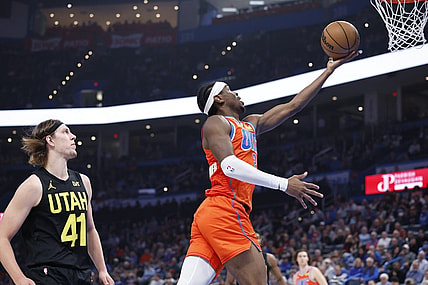 Dec 11, 2023; Oklahoma City, Oklahoma, USA; Oklahoma City Thunder guard Shai Gilgeous-Alexander (2) shoots ahead of Utah Jazz forward Kelly Olynyk (41) during the second quarter at Paycom Center. Mandatory Credit: Alonzo Adams-USA TODAY Sports