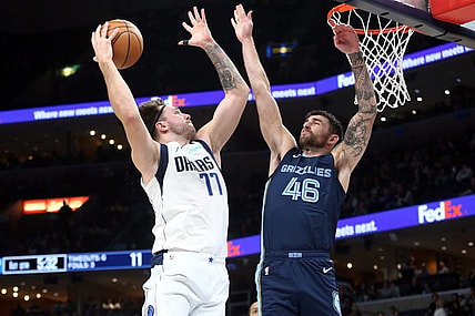 Dec 11, 2023; Memphis, Tennessee, USA; Dallas Mavericks guard Luka Doncic (77) drives to the basket as Memphis Grizzlies guard John Konchar (46) defends during the first half at FedExForum. Mandatory Credit: Petre Thomas-USA TODAY Sports