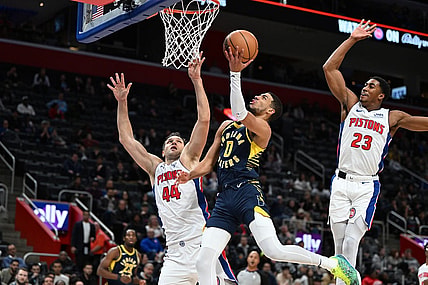 Dec 11, 2023; Detroit, Michigan, USA;  Indiana Pacers guard Tyrese Haliburton (0) drives to the basket against Detroit Pistons forward Bojan Bogdanovic (44) and Pistons guard Jaden Ivey (23) in the second quarter at Little Caesars Arena. Mandatory Credit: Lon Horwedel-USA TODAY Sports