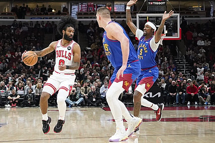 Dec 12, 2023; Chicago, Illinois, USA; Denver Nuggets forward Aaron Gordon (50) defends Chicago Bulls guard Coby White (0) during the first half at United Center. Mandatory Credit: David Banks-USA TODAY Sports