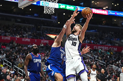 Dec 6, 2023; Los Angeles, California, USA; Sacramento Kings forward Domantas Sabonis (10) shoots the ball against LA Clippers center Ivica Zubac (40) in the second half at Crypto.com Arena. Mandatory Credit: Kirby Lee-USA TODAY Sports