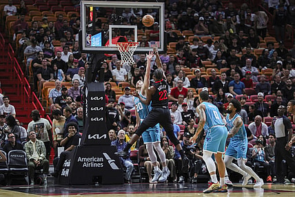 Dec 13, 2023; Miami, Florida, USA; Miami Heat forward Jimmy Butler (22) shoots the basketball over Charlotte Hornets forward Gordon Hayward (20) during the first quarter at Kaseya Center. Mandatory Credit: Sam Navarro-USA TODAY Sports