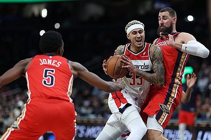 Dec 13, 2023; Washington, District of Columbia, USA; Washington Wizards forward Kyle Kuzma (33) drives to the basket as New Orleans Pelicans center Jonas Valanciunas (17) defends in the second quarter at Capital One Arena. Mandatory Credit: Geoff Burke-USA TODAY Sports