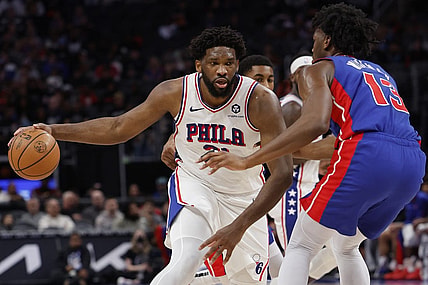 Dec 13, 2023; Detroit, Michigan, USA;  Philadelphia 76ers center Joel Embiid (21) is defended by Detroit Pistons center James Wiseman (13) in the first half at Little Caesars Arena. Mandatory Credit: Rick Osentoski-USA TODAY Sports