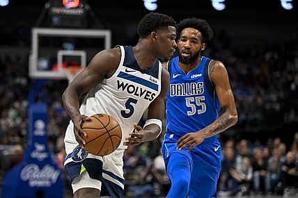 Dec 14, 2023; Dallas, Texas, USA; Minnesota Timberwolves guard Anthony Edwards (5) looks to move the ball past Dallas Mavericks forward Derrick Jones Jr. (55) during the first quarter at the American Airlines Center. Mandatory Credit: Jerome Miron-USA TODAY Sports