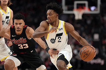 Dec 14, 2023; Portland, Oregon, USA; Utah Jazz point guard Collin Sexton (2) dribbles the ball while defended by Portland Trail Blazers forward Toumani Camara (33) during the first half at Moda Center. Mandatory Credit: Soobum Im-USA TODAY Sports