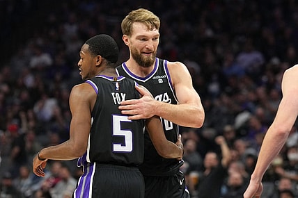 Dec 14, 2023; Sacramento, California, USA; Sacramento Kings guard De'Aaron Fox (5) is congratulated by forward Domantas Sabonis (10) after a basket against the Oklahoma City Thunder during the second quarter at Golden 1 Center. Mandatory Credit: Darren Yamashita-USA TODAY Sports