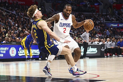 Dec 14, 2023; Los Angeles, California, USA; LA Clippers forward Kawhi Leonard (2) dribbles against Golden State Warriors guard Brandin Podziemski (2) and draws an offensive foul during the second half of the game at Crypto.com Arena. Mandatory Credit: Jessica Alcheh-USA TODAY Sports