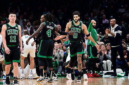 Dec 15, 2023; Boston, Massachusetts, USA; Boston Celtics forward Jayson Tatum (0) reacts to his shot with guard Jrue Holiday (4) during the first half against the Orlando Magic at TD Garden. Mandatory Credit: Eric Canha-USA TODAY Sports