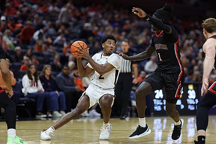 Dec 16, 2023; Charlottesville, Virginia, USA; Virginia Cavaliers guard Reece Beekman (2) holds the ball as Northeastern Huskies guard Masai Troutman (1) defends in the second half at John Paul Jones Arena. Mandatory Credit: Geoff Burke-USA TODAY Sports