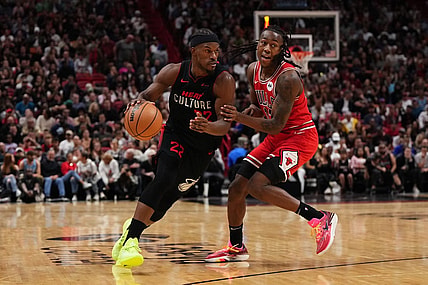 Dec 16, 2023; Miami, Florida, USA; Miami Heat forward Jimmy Butler (22) drives the ball around Chicago Bulls guard Ayo Dosunmu (12) during the second half at Kaseya Center. Mandatory Credit: Jasen Vinlove-USA TODAY Sports