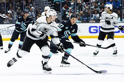 Dec 16, 2023; Seattle, Washington, USA; Los Angeles Kings left wing Kevin Fiala (22) looks to pass the puck against the Seattle Kraken during the second period at Climate Pledge Arena. Mandatory Credit: Joe Nicholson-USA TODAY Sports