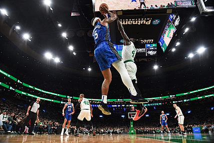 Dec 17, 2023; Boston, Massachusetts, USA;  Orlando Magic forward Paolo Banchero (5) shoots the ball over Boston Celtics guard Jrue Holiday (4) during the first half at TD Garden. Mandatory Credit: Bob DeChiara-USA TODAY Sports