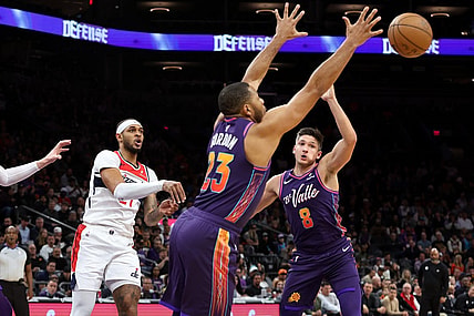 Dec 17, 2023; Phoenix, Arizona, USA; Phoenix Suns guard Eric Gordon (23) gets a steel from Washington Wizards center Daniel Gafford (21) during the first quarter at Footprint Center. Mandatory Credit: Zachary BonDurant-USA TODAY Sports