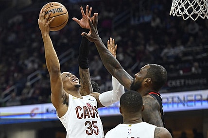 Dec 18, 2023; Cleveland, Ohio, USA; Cleveland Cavaliers forward Isaac Okoro (35) drives to the basket beside Houston Rockets forward Jeff Green (32) in the second quarter at Rocket Mortgage FieldHouse. Mandatory Credit: David Richard-USA TODAY Sports