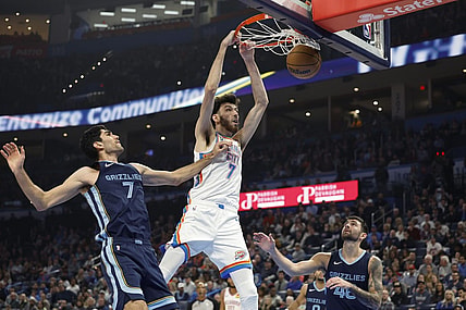 Dec 18, 2023; Oklahoma City, Oklahoma, USA; Oklahoma City Thunder forward Chet Holmgren (7) dunks against Memphis Grizzlies forward Santi Aldama (7) during the second quarter at Paycom Center. Mandatory Credit: Alonzo Adams-USA TODAY Sports