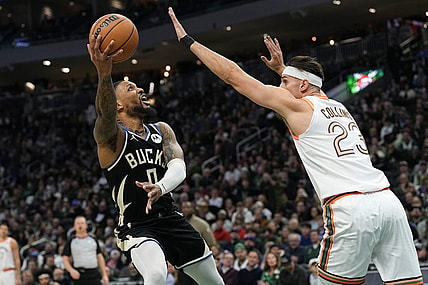 Dec 19, 2023; Milwaukee, Wisconsin, USA;  Milwaukee Bucks guard Damian Lillard (0) shoots around San Antonio Spurs center Zach Collins (23) during the first quarter at Fiserv Forum. Mandatory Credit: Jeff Hanisch-USA TODAY Sports