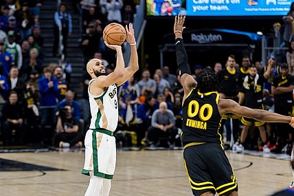Dec 19, 2023; San Francisco, California, USA; Boston Celtics guard Derrick White (9) shoots over Golden State Warriors forward Jonathan Kuminga (00) during the second half at Chase Center. Mandatory Credit: John Hefti-USA TODAY Sports