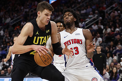 Dec 21, 2023; Detroit, Michigan, USA;  Utah Jazz center Walker Kessler (24) is defended by Detroit Pistons center James Wiseman (13) in the second half at Little Caesars Arena. Mandatory Credit: Rick Osentoski-USA TODAY Sports