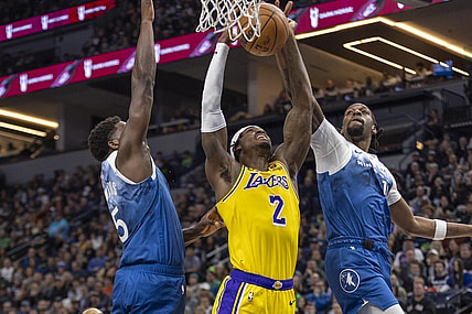 Dec 21, 2023; Minneapolis, Minnesota, USA; Minnesota Timberwolves center Naz Reid (11) jumps up and blocks a shot from Los Angeles Lakers forward Jarred Vanderbilt (2) as Minnesota Timberwolves guard Anthony Edwards (5) plays defense in the first half at Target Center. Mandatory Credit: Jesse Johnson-USA TODAY Sports