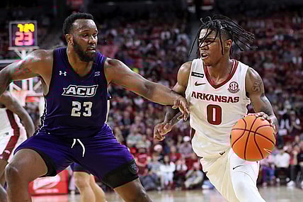 Dec 21, 2023; Fayetteville, Arkansas, USA; Arkansas Razorbacks guard Khalif Battle (0) drives against Abilene Christian Wildcats forward Airion Simmons (23) during the second half at Bud Walton Arena. Arkansas won 83-73. Mandatory Credit: Nelson Chenault-USA TODAY Sports
