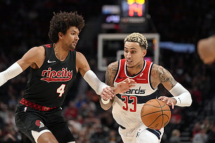 Dec 21, 2023; Portland, Oregon, USA; Washington Wizards small forward Kyle Kuzma (33) dribbles the ball as Portland Trail Blazers shooting guard Matisse Thybulle (4) defends during the first half at Moda Center. Mandatory Credit: Soobum Im-USA TODAY Sports