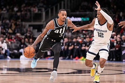 Dec 23, 2023; Atlanta, Georgia, USA; Atlanta Hawks guard Dejounte Murray (5) dribbles against Memphis Grizzlies guard Ja Morant (12) during the first half at State Farm Arena. Mandatory Credit: Dale Zanine-USA TODAY Sports