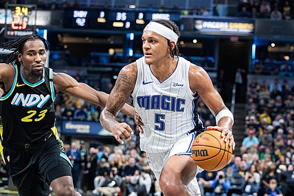 Dec 23, 2023; Indianapolis, Indiana, USA; Orlando Magic forward Paolo Banchero (5) dribbles the ball while Indiana Pacers forward Aaron Nesmith (23) defends in the second half at Gainbridge Fieldhouse. Mandatory Credit: Trevor Ruszkowski-USA TODAY Sports