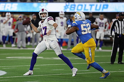 Dec 23, 2023; Inglewood, California, USA;  Buffalo Bills quarterback Josh Allen (17) throws a pass while Los Angeles Chargers linebacker Khalil Mack (52) pressuring him during the fourth quarter at SoFi Stadium. Mandatory Credit: Kiyoshi Mio-USA TODAY Sports