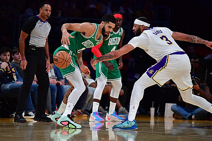 Dec 25, 2023; Los Angeles, California, USA; Boston Celtics forward Jayson Tatum (0) loses the ball against Los Angeles Lakers forward Anthony Davis (3) during the first half at Crypto.com Arena. Mandatory Credit: Gary A. Vasquez-USA TODAY Sports