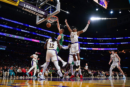 Dec 25, 2023; Los Angeles, California, USA; Boston Celtics center Kristaps Porzingis (8) dunks for the basket against Los Angeles Lakers forward Rui Hachimura (28) and forward Taurean Prince (12) during the second half at Crypto.com Arena. Mandatory Credit: Gary A. Vasquez-USA TODAY Sports
